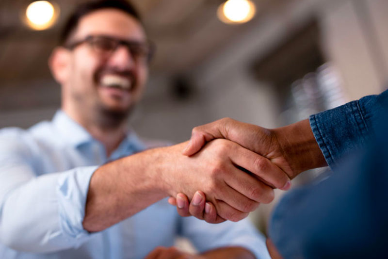 man shaking someone's hand out of frame