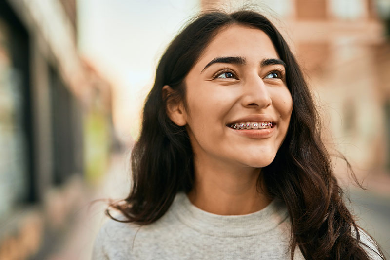 girl wearing braces smiling outside