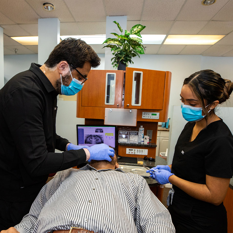 Dr. Asim performing dental treatment