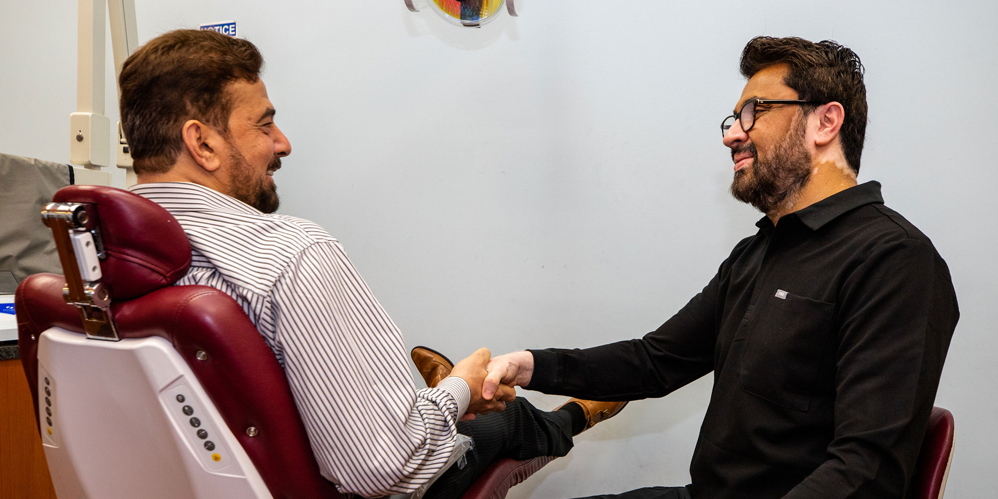 Dr. Asim shaking patients' hand