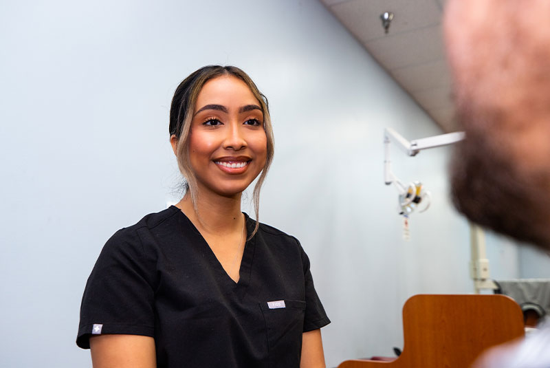 dental assistant smiling at dental patient