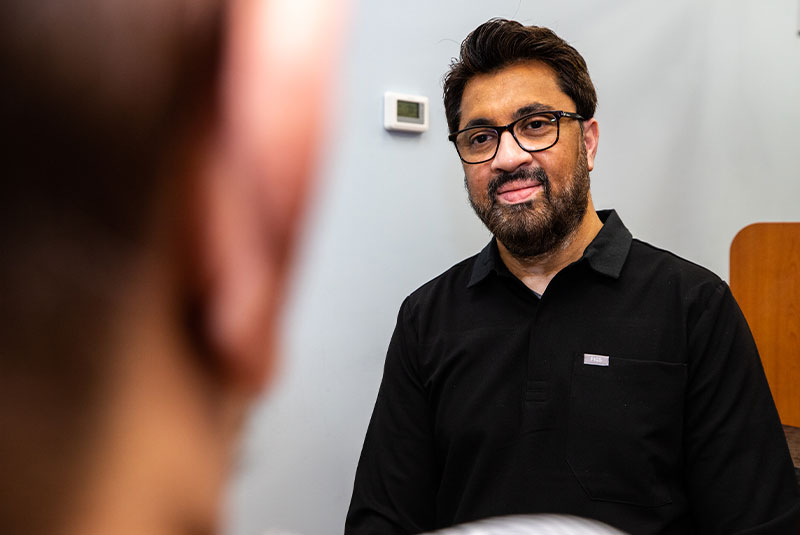 Dr. Asim explaining dental implant treatment