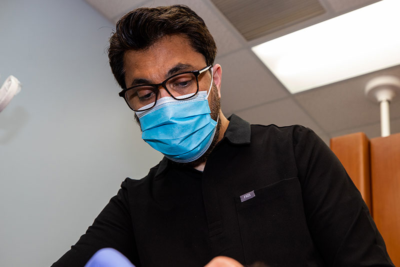 Dr. Asim performing dental implant treatment