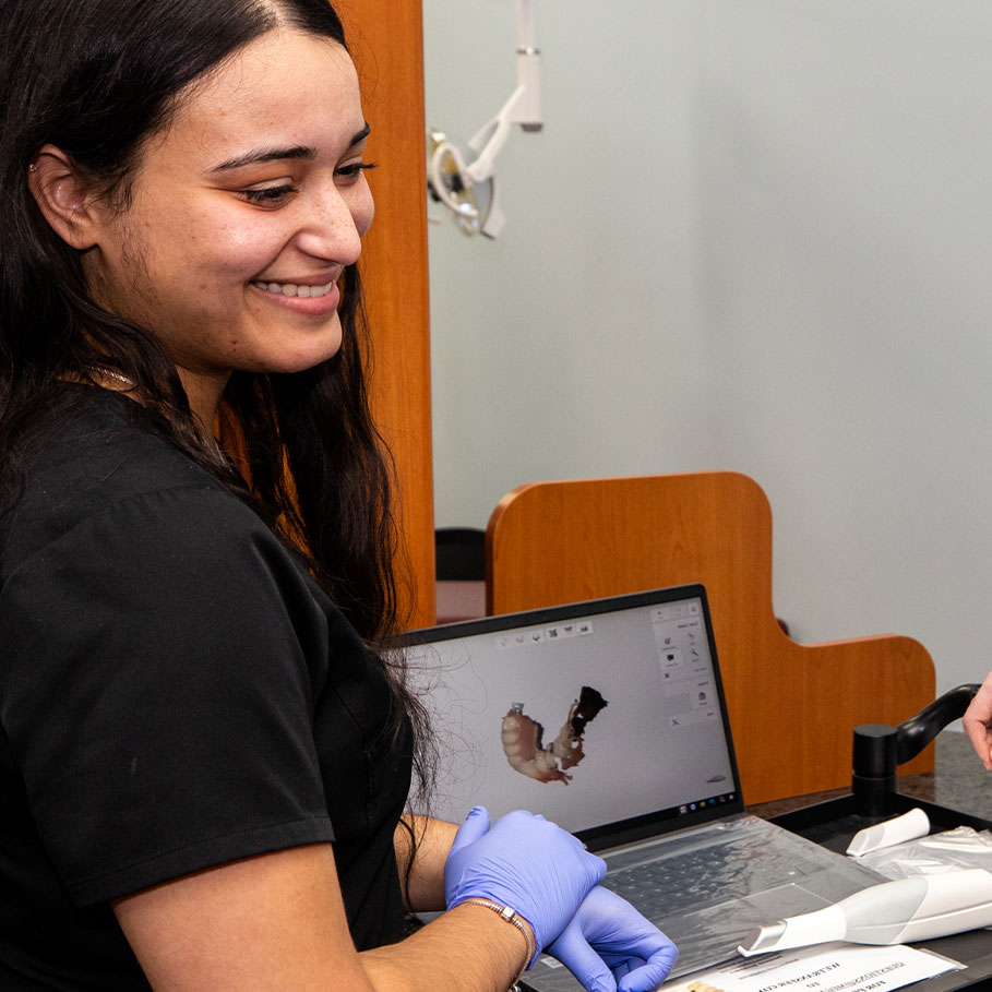 dental assistant going over full mouth reconstruction treatment
