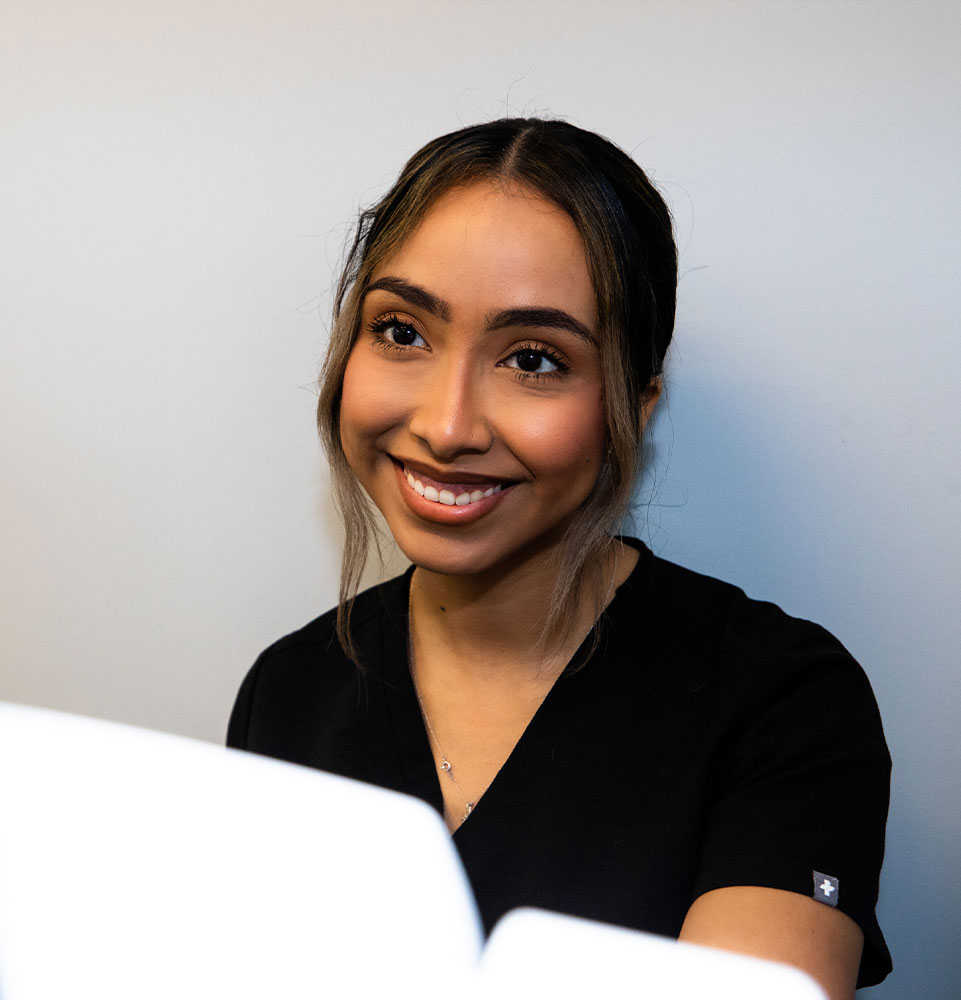 staff member helping patient within the dental practice