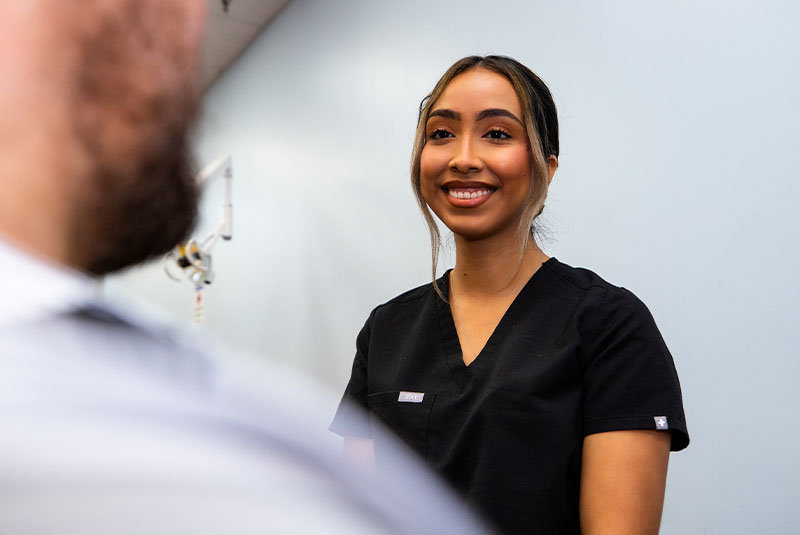 staff member helping patient within the dental practice