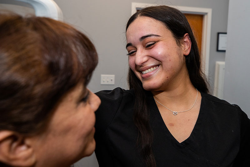 staff member helping with patient within the dental practice